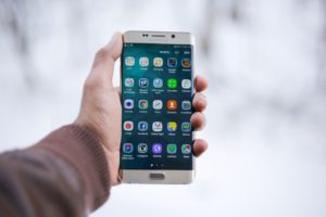 C'est une personne qui tient un smartphone.
